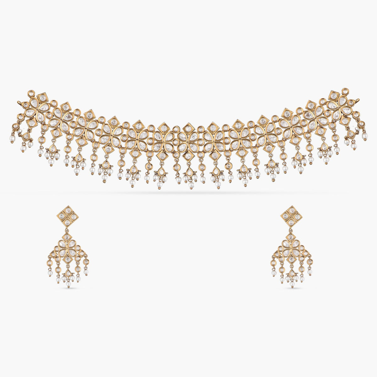 A picture of an Indian artificial jewelry set with a gold-toned choker necklace and matching earrings with Cubic Zirconia stones.