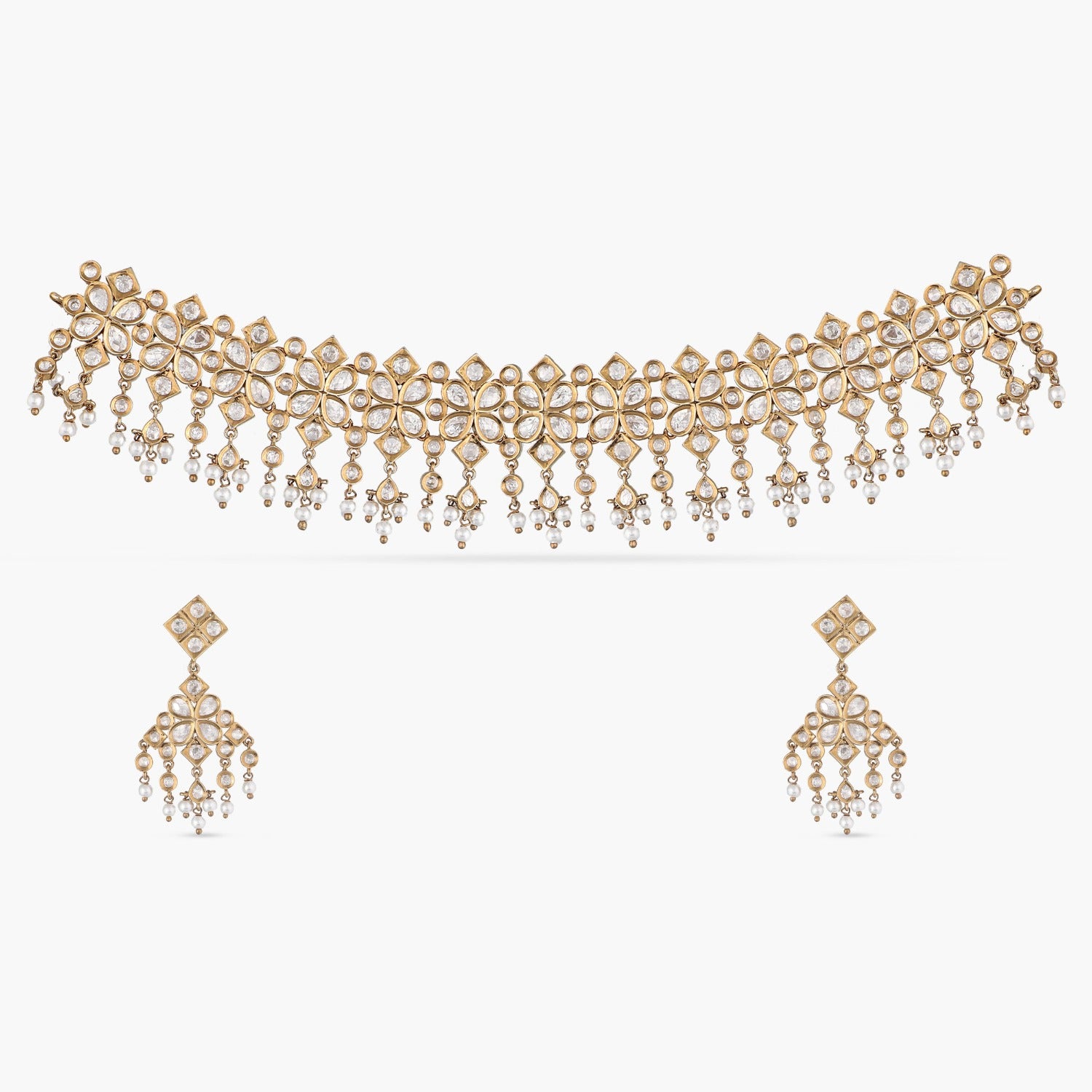 A picture of an Indian artificial jewelry set with a gold-toned choker necklace and matching earrings with Cubic Zirconia stones.
