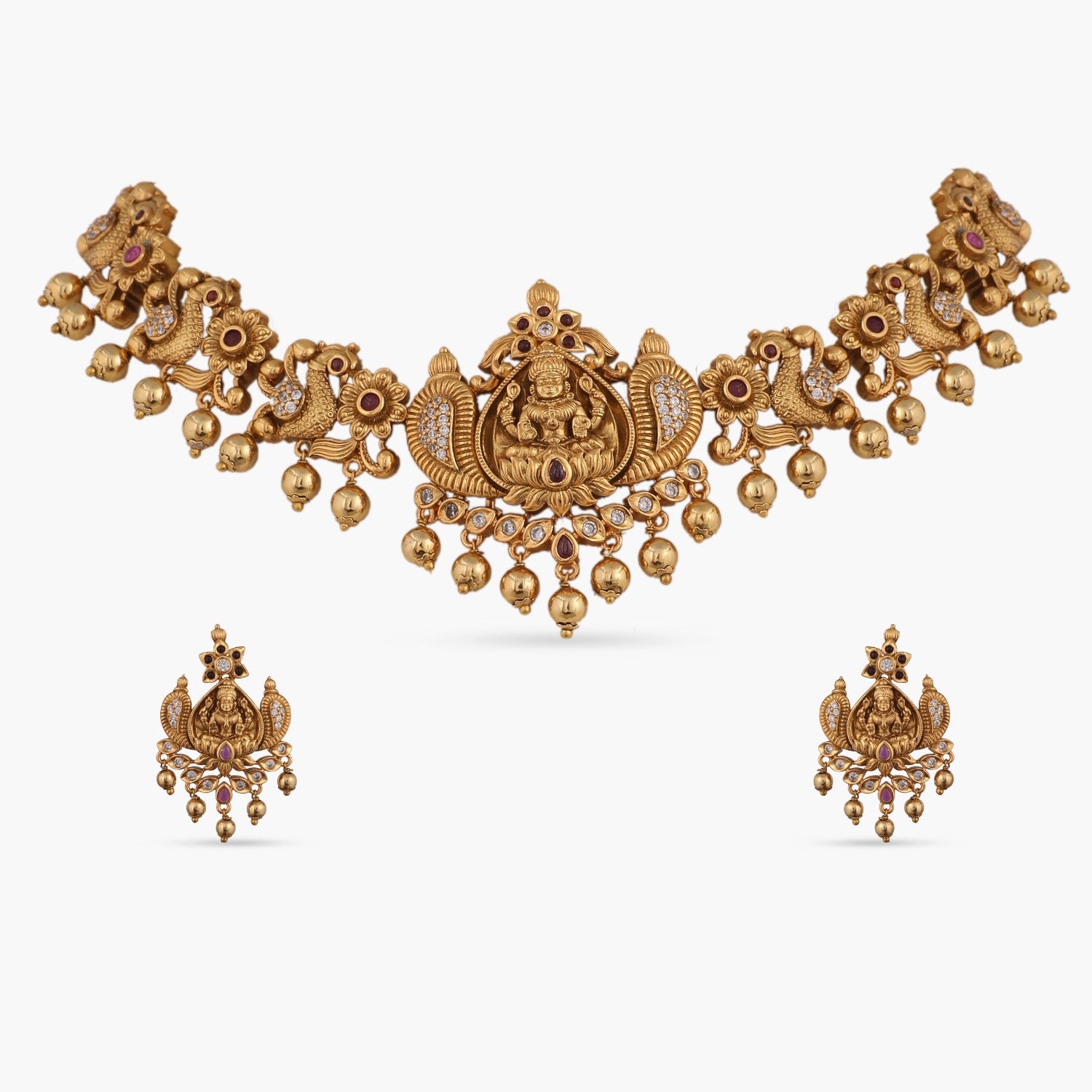 A picture of an Indian artificial jewelry set: an antique gold-toned necklace and earrings with Goddess Laxmi motifs on a white background