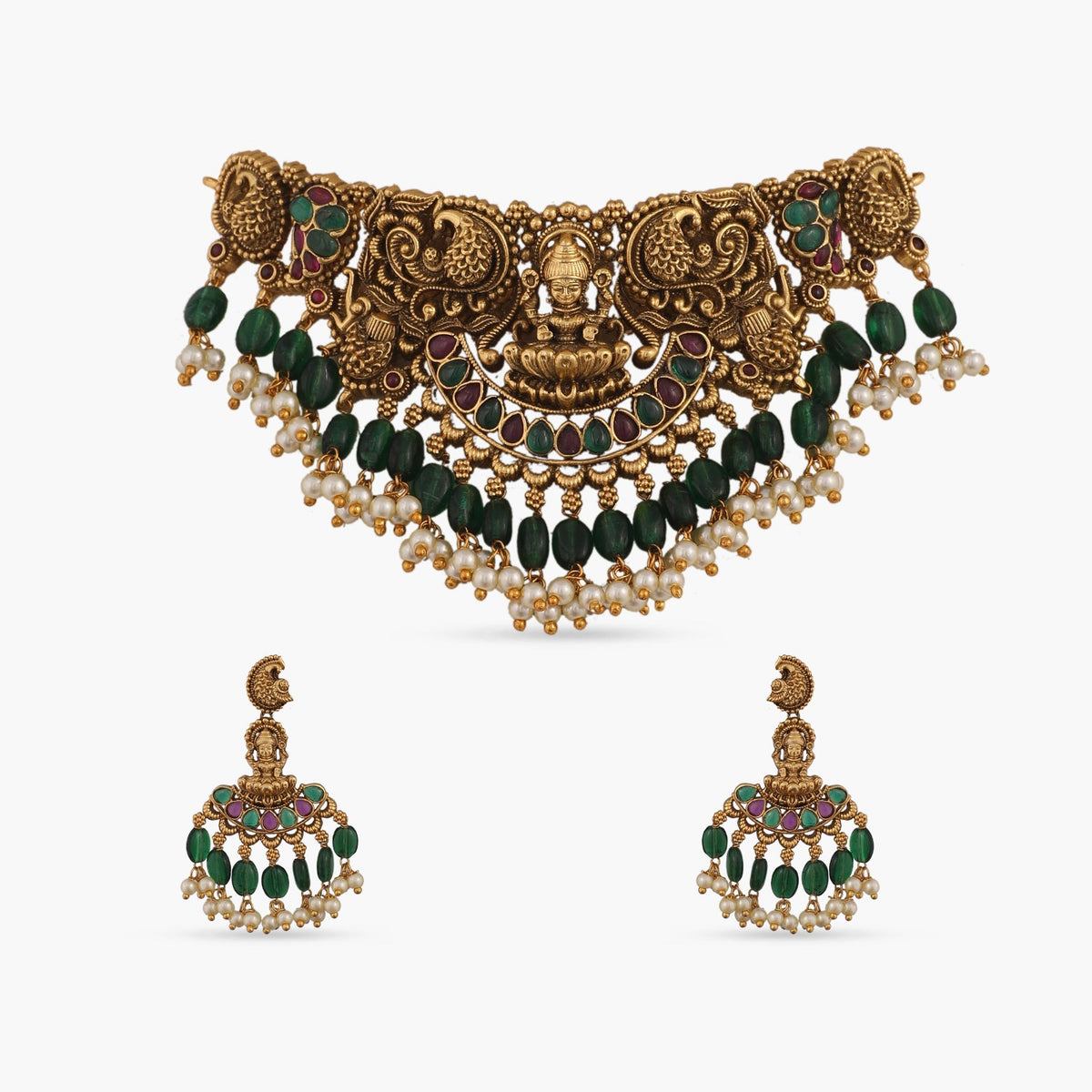A picture of Indian artificial jewelry. It is an antique gold plated choker with green beads, divine Laxmi pendant and peacock motifs.