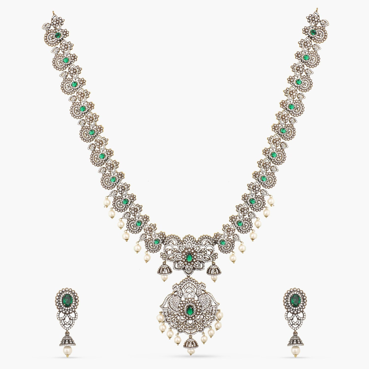 A picture of an Indian artificial jewelry set: an antique plated necklace and earrings set with green gemstones and Cubic Zirconia on a white background.