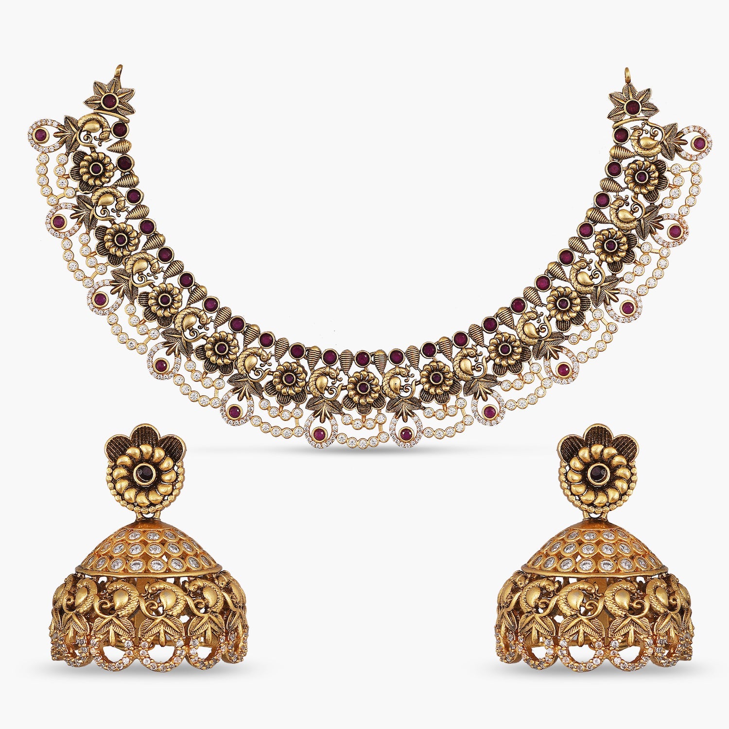 A picture of Indian artificial jewelry. It is a short necklace and earring set with peacock design made of colorful gemstones and Cubic Zirconia..