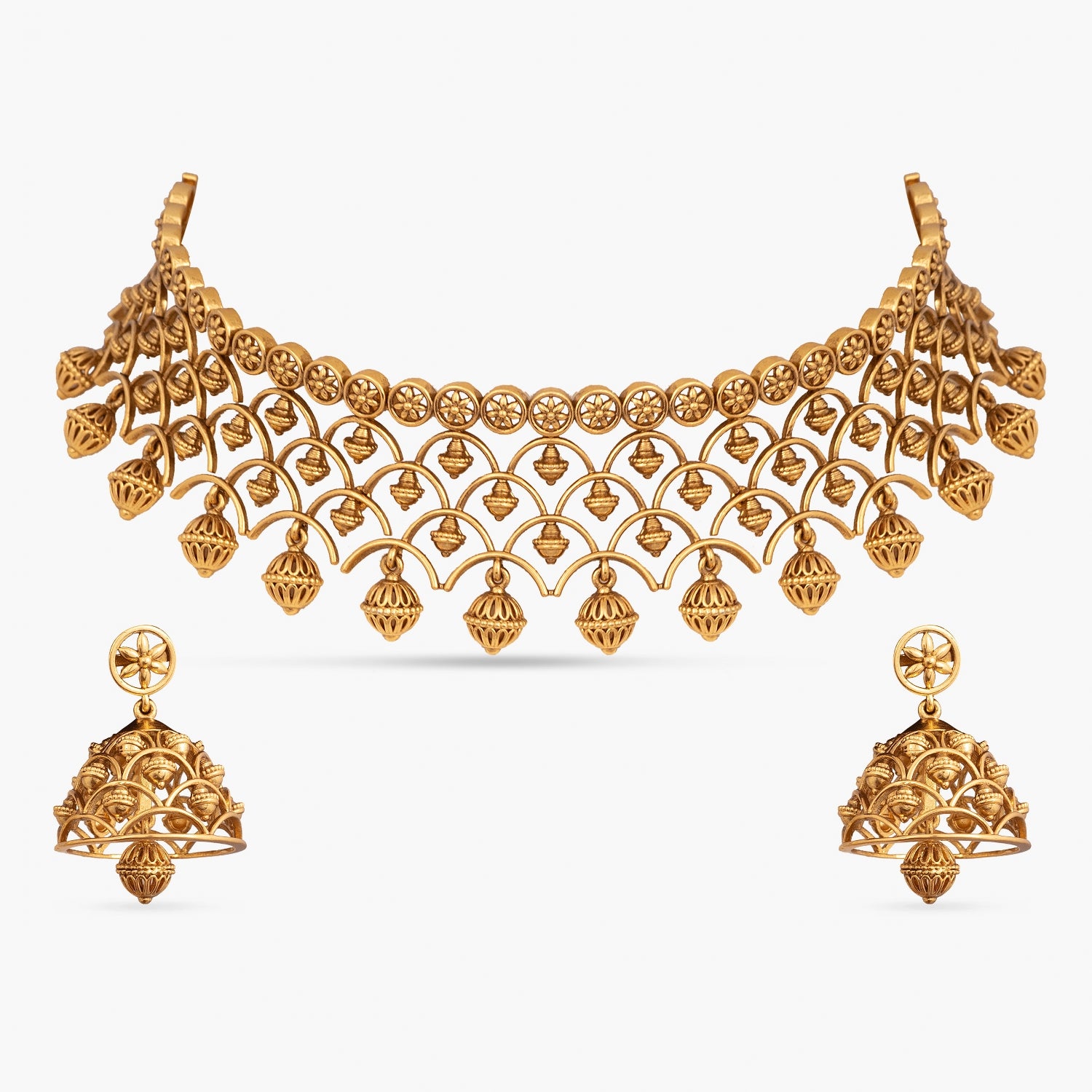 A picture of an Indian artificial antique jewelry set with a gold-toned choker necklace and matching jhumka earrings.