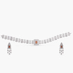 A picture of Indian artificial jewelry. It is a choker necklace and matching earrings set with Cubic Zirconia and red gemstones on a white background.
