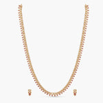 A picture of an Indian artificial jewelry set with a gold-toned necklace and matching earrings, featuring Cubic Zirconia, red gemstones.