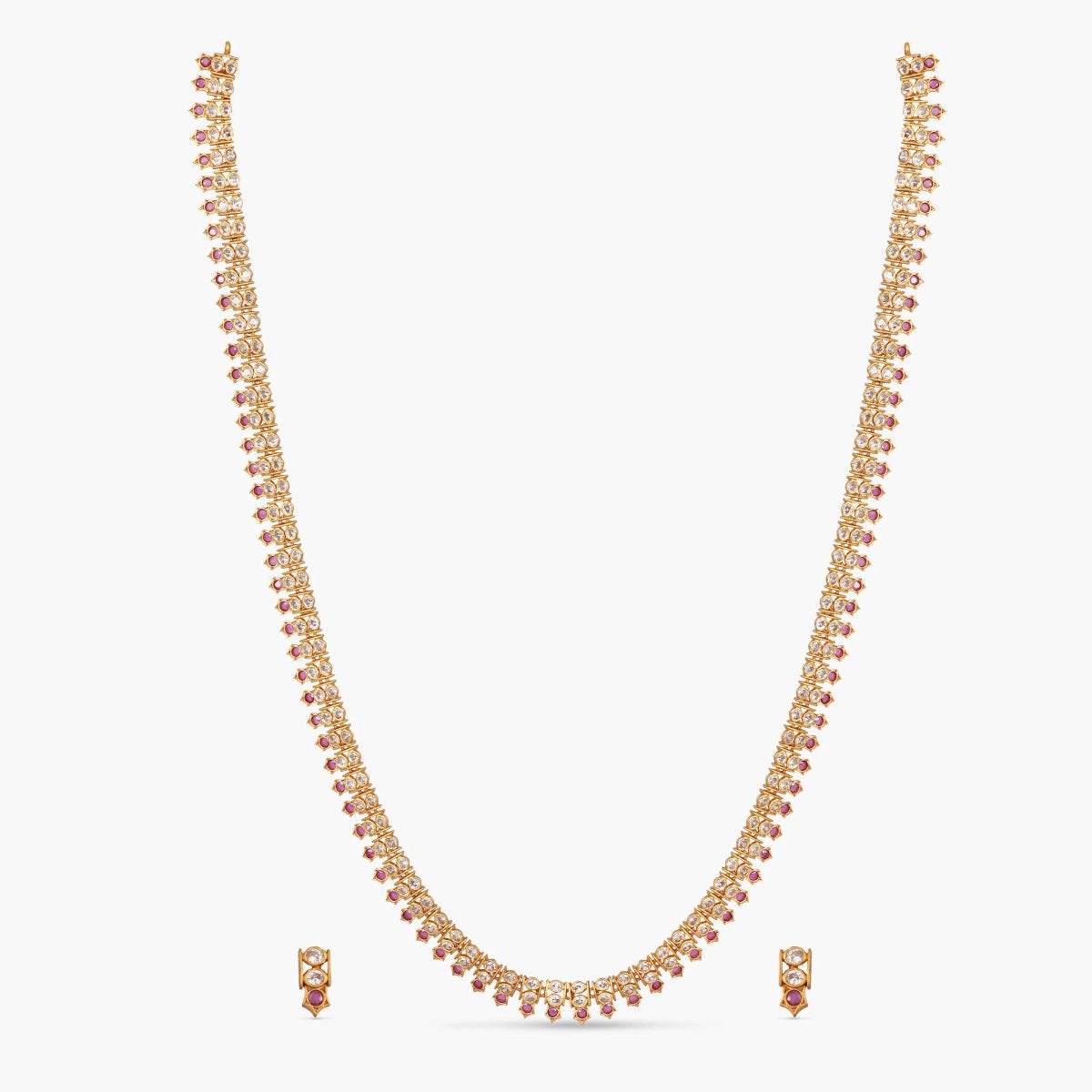 A picture of an Indian artificial jewelry set with a gold-toned necklace and matching earrings, featuring Cubic Zirconia, red gemstones.