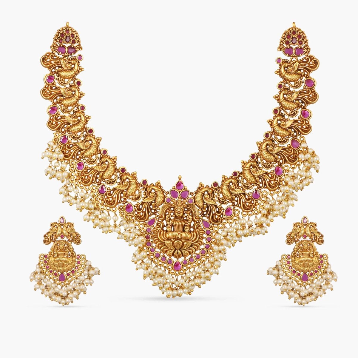 A picture of an Indian artificial gold plated necklace set with a divine Goddess Laxmi motif pendant with matching earrings.